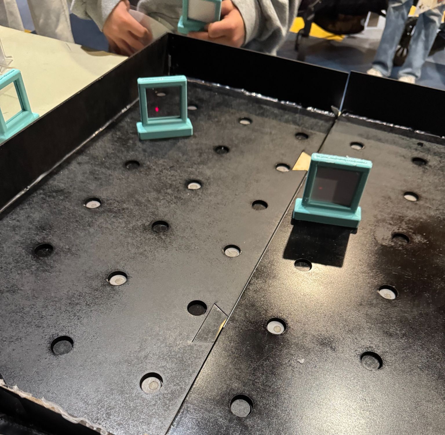 Mirror stands and laser beam on the maze board